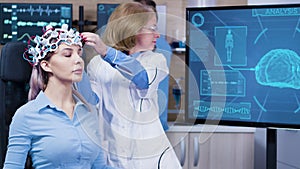 Woman wearing brain waves headset sitting on a chair