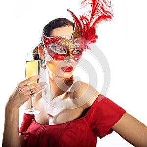 Woman wearing carnival mask with glass of champagne