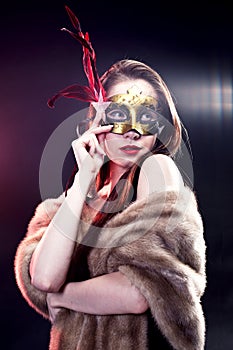 Woman wearing carnival venetian mask on blur background