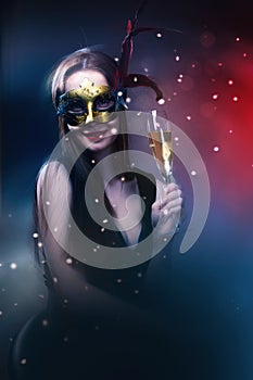 Woman wearing carnival venetian mask on blur background.