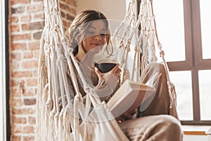 Woman wearing cashmere nightwear relaxing in cabin photo