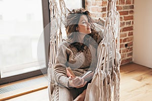 Woman wearing cashmere nightwear relaxing in cabin photo