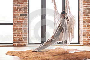 Woman wearing cashmere nightwear relaxing on hammock in cabin photo