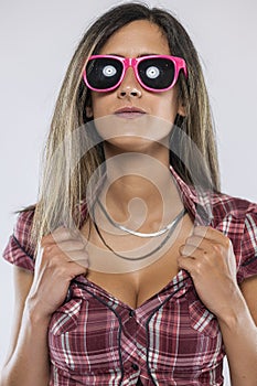 Woman wearing checkered shirt and pink sunglasses