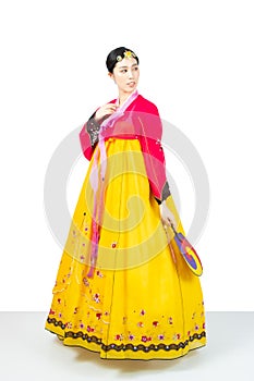 The woman wearing colorful Hanbok, Korean traditional dress on white background isolated.