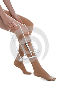 Woman wearing compression tights with donner on white background, closeup