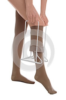 Woman wearing compression tights with donner on white background, closeup