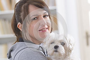 Woman wearing deaf aid with her dog