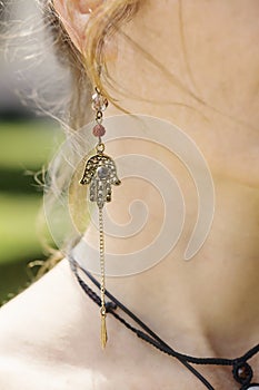 Woman wearing decorative earrings