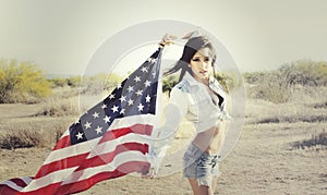 Woman wearing denim shirt holding American flag