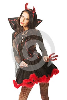 woman wearing devil clothes, standin astride, holding trident