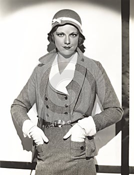 Woman wearing dress suit with matching hat