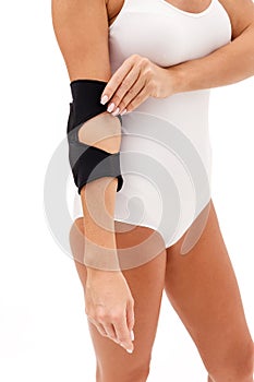 A Woman Wearing Elbow Brace Over White Background