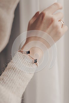 Woman wearing elegant bracelet with diamonds on close-up