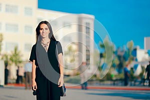 Woman Wearing Elegant Romper and Statement Necklace at Outdoor Event