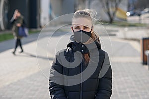 Woman wearing face mask because of Air pollution or virus epidemic in the city