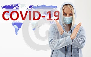 Woman wearing face mask. Concept coronavirus, respiratory virus. Sign with hands Stop. Text Covid-19
