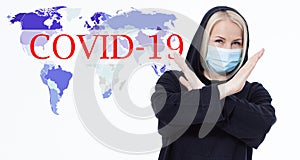 Woman wearing face mask. Concept coronavirus, respiratory virus. Sign with hands stop. Text Covid-19