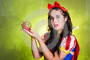 Woman wearing a fairy tale dress holding an apple with radiation symbol. Environmental problems concept, radioactive
