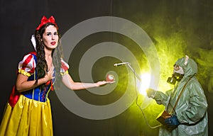 Woman wearing a fairy tale dress holding an apple with radiation symbol. Environmental problems concept, radioactive