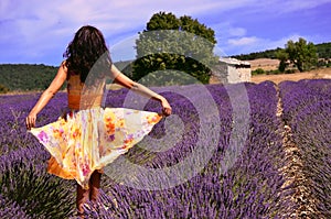 Woman wearing a floating dress in a lavender field