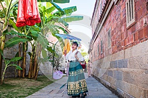 A woman wearing a flower crown and an ancient Chinese horse face skirt