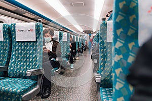 A woman wearing flu mask sitting in Taiwan High Speed Rail THSR in the morning in Taiwan, Taipei