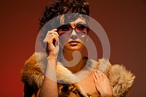 Woman wearing fur and glasses photo