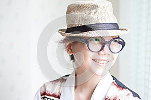 Woman wearing a glasses and straw hat smilling