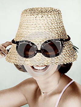 Woman wearing hat with fake sunglasses