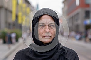 Woman wearing a head scarf in an urban street