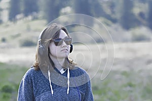 Woman wearing headphones enjoying nature