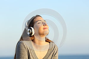 Woman wearing headphones meditating listening to music