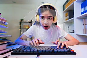 woman wearing headset and hand raises arms and fists clenched with shows strong powerful.