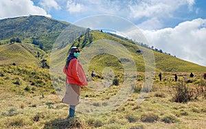 A woman wearing hijab standing on savana