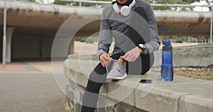 Woman wearing hijab tying her shoelaces