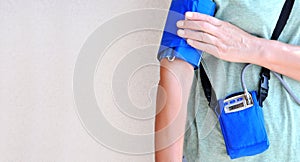 Woman wearing holter monitor device for daily monitoring of an electrocardiogram. Health care and disease prevention.