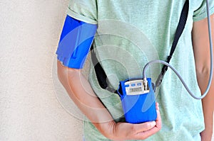 Woman wearing holter monitor device for daily monitoring of an electrocardiogram. photo