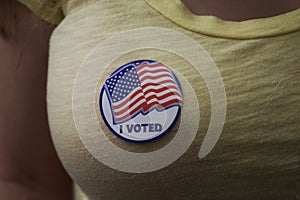 Woman wearing an I voted sticker on election day