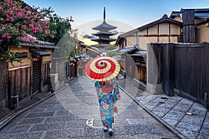 Woman wearing japanese traditional kimono with umbrella at Yasaka Pagoda and Sannen Zaka Street in Kyoto, Japan