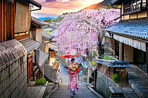 Woman wearing japanese traditional kimono walking at Historic Higashiyama district in spring, Kyoto in Japan