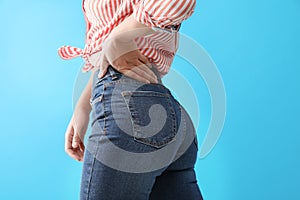 Woman wearing jeans on blue background