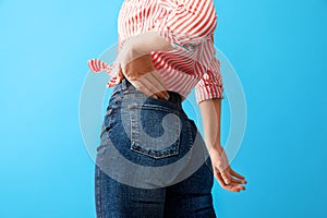 Woman wearing jeans on blue background