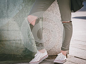 Woman wearing jeans with holes on knees