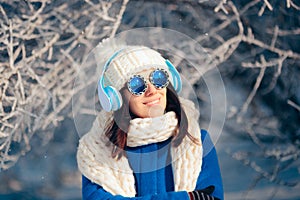 Woman Wearing Knitted Beanie and Scarf Listening to Music