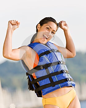 Woman wearing life jacket at beach