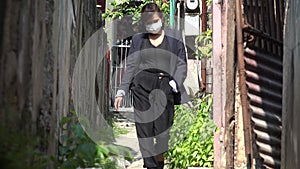 Woman Wearing Mask Walking In Small Pathway