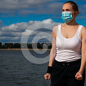 Woman wearing medical mask, Coronavirus pandemic Covid-19. Sport, Active life in quarantine.