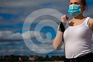 Woman wearing medical mask, Coronavirus pandemic Covid-19. Sport, Active life in quarantine.