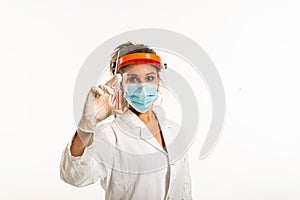 Woman wearing medical uniform showing a phial